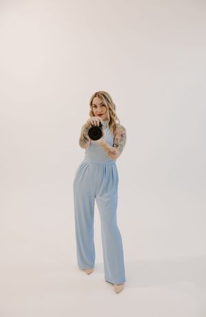 Fashion photography of light blue jumpsuit outfit shown in multiple poses on white background.