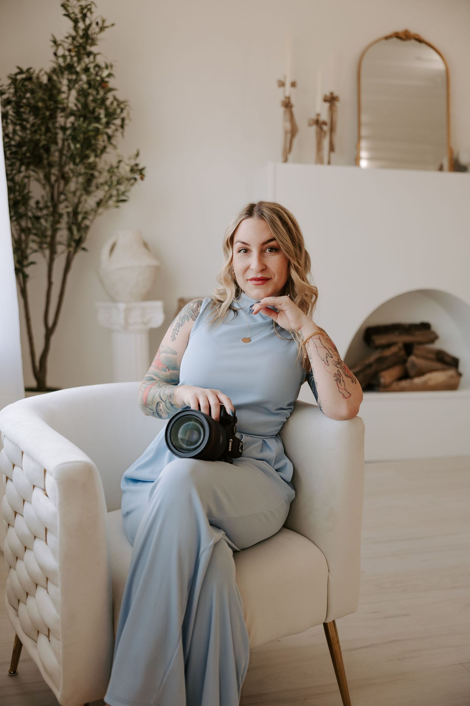Lifestyle photography session in a bright interior featuring a plush white armchair and natural decor elements.
