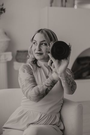 Black and white self-portrait series showing photographer with vintage camera.
