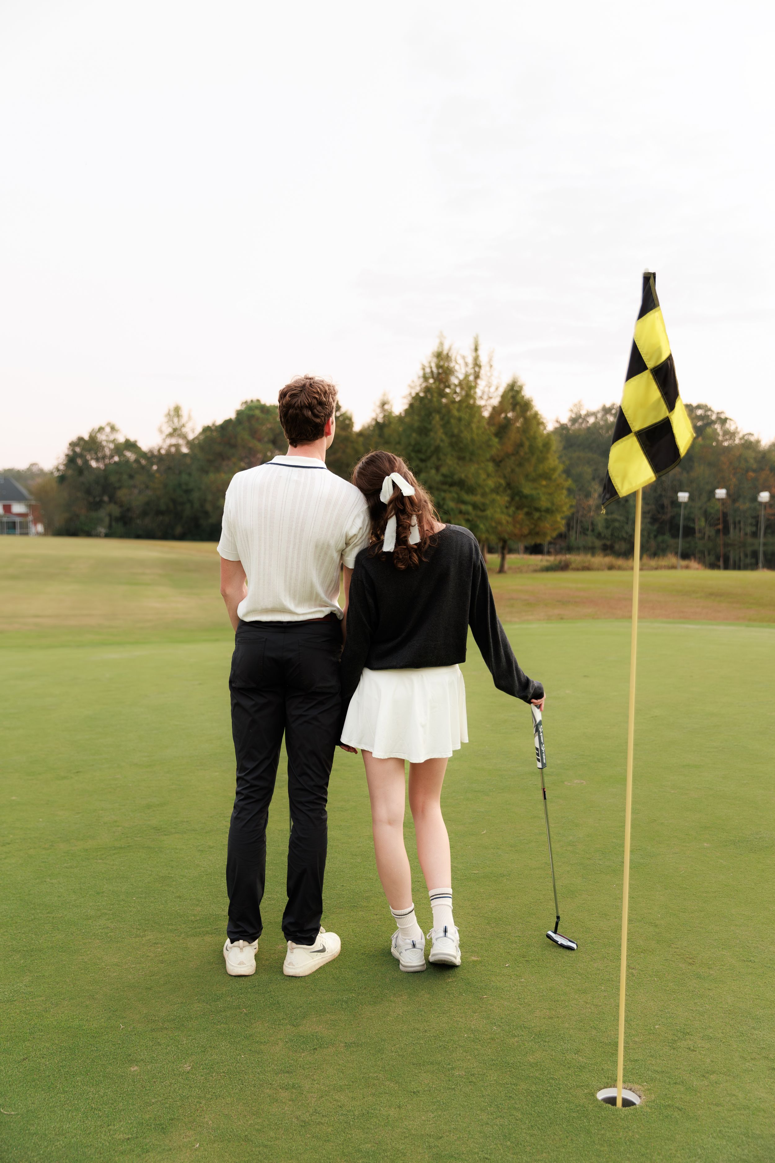 A series of four golf photos showing couples standing together on a putting green with yellow flags.