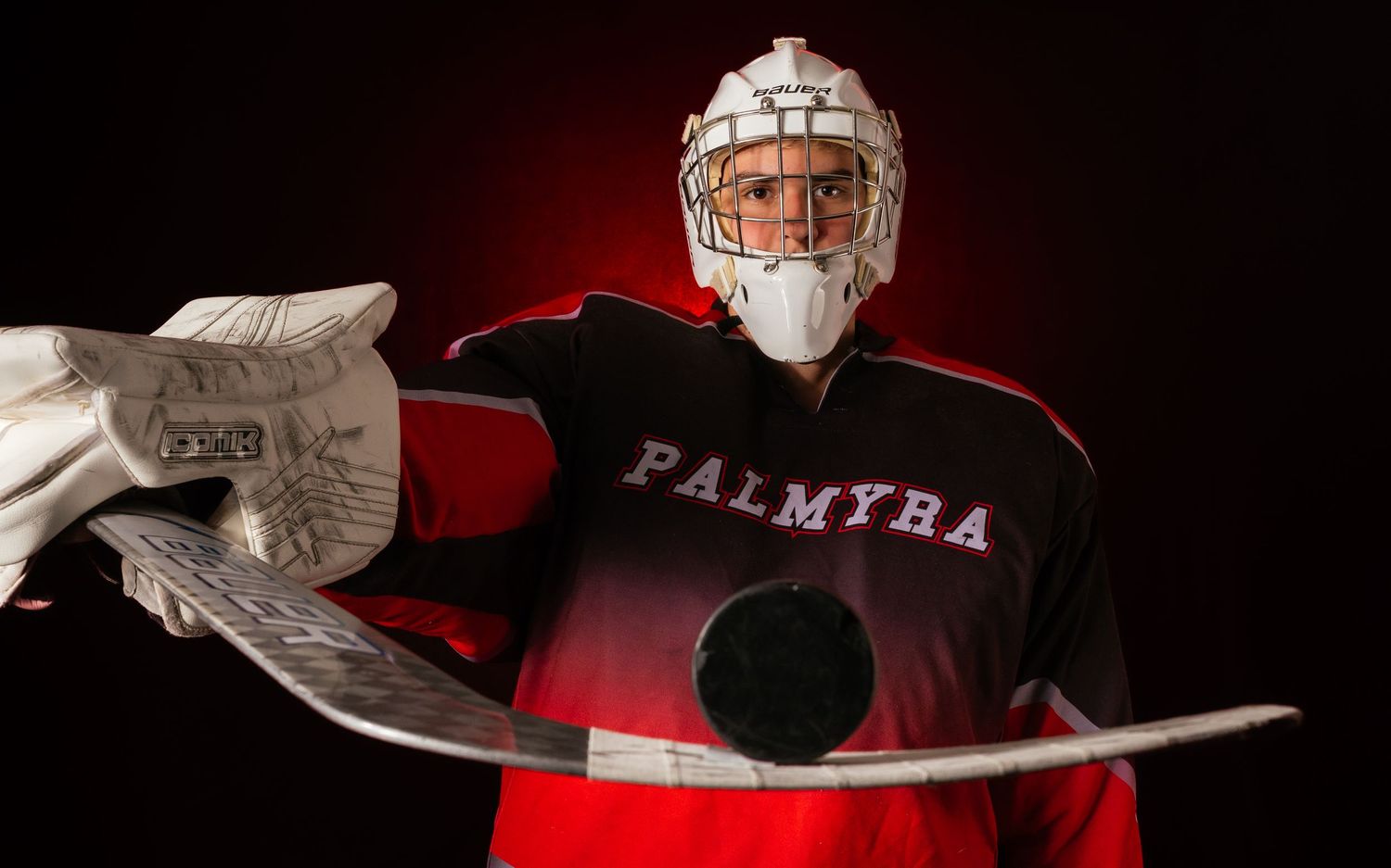 Palmyra Black Knights hockey player in red jersey, media day portrait, Palmyra Pennsylvania, by SportsFox Photography.