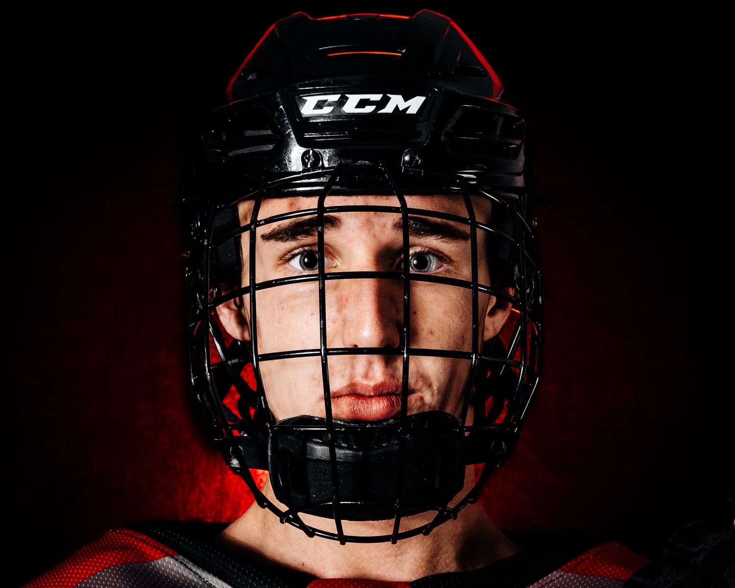 Palmyra Black Knights hockey player in red jersey, media day portrait, Palmyra Pennsylvania, by SportsFox Photography.