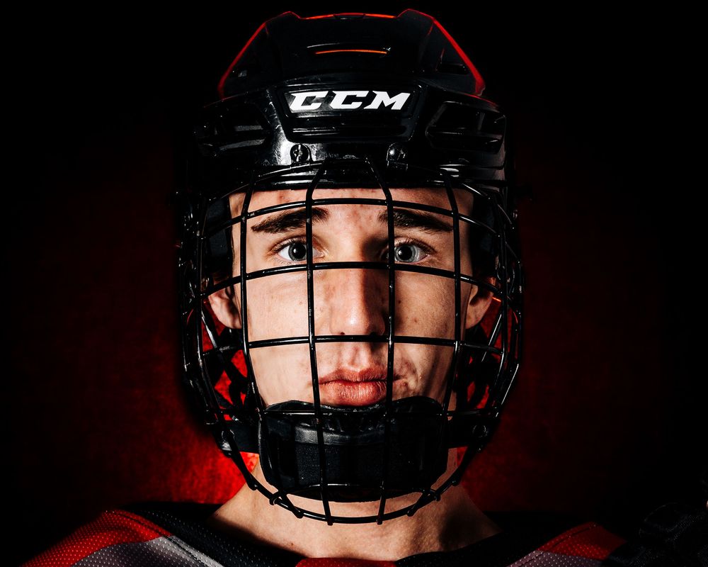 Palmyra Black Knights hockey player in red jersey, media day portrait, Palmyra Pennsylvania, by SportsFox Photography.