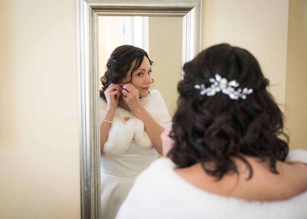 Closeup shots of bridal hair and accessories being styled in an indoor setting.