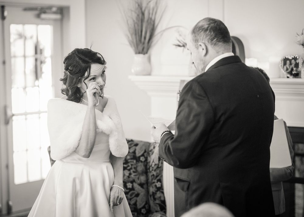A series of black and white wedding photographs arranged in a horizontal collage showing intimate moments at a ceremony.