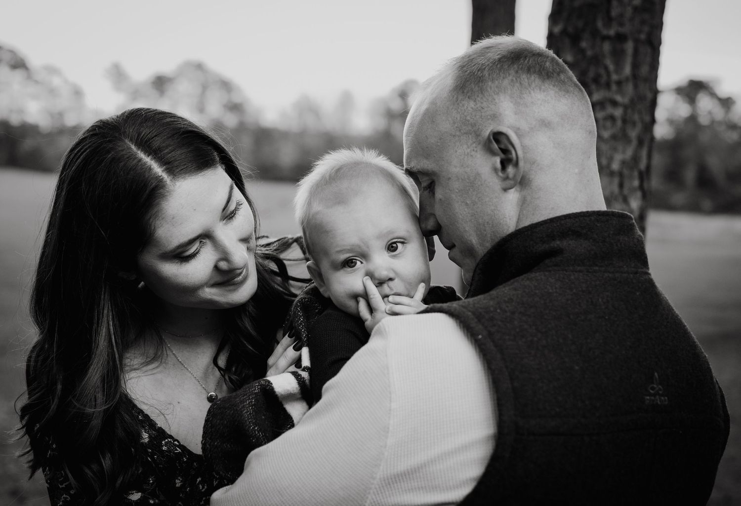 Intimate black and white family portrait series outdoors.
