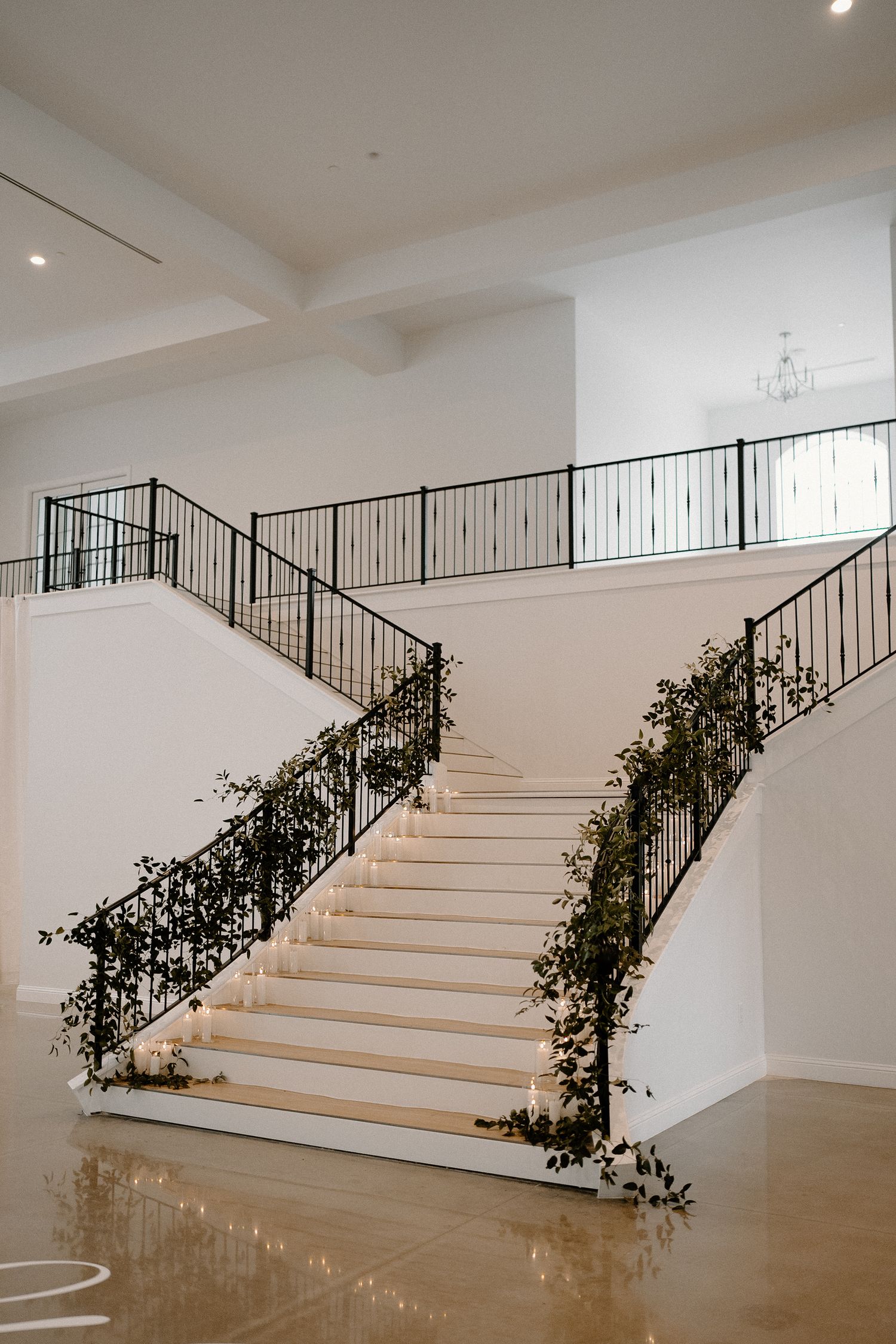 Modern white staircase with black metal railings at The Grand at Willow Springs.