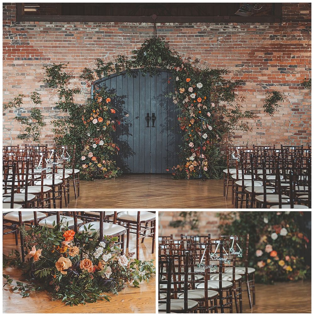 Rustic wedding ceremony setup with wooden chairs and floral arrangements against a brick wall with a blue door.
