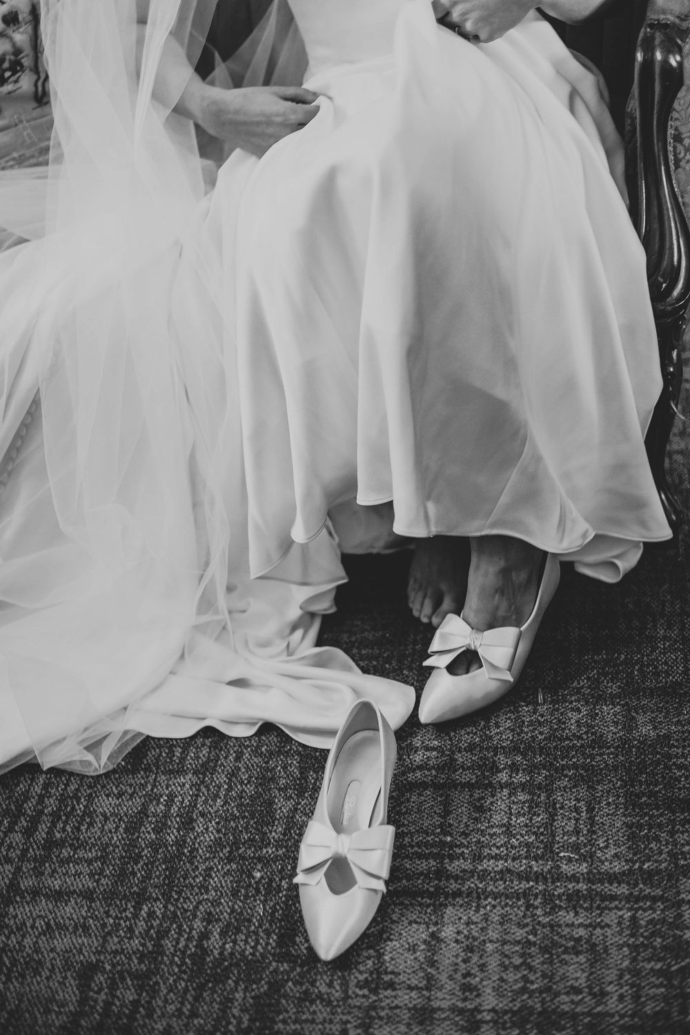 Bridal high heals that have a bow under the dress