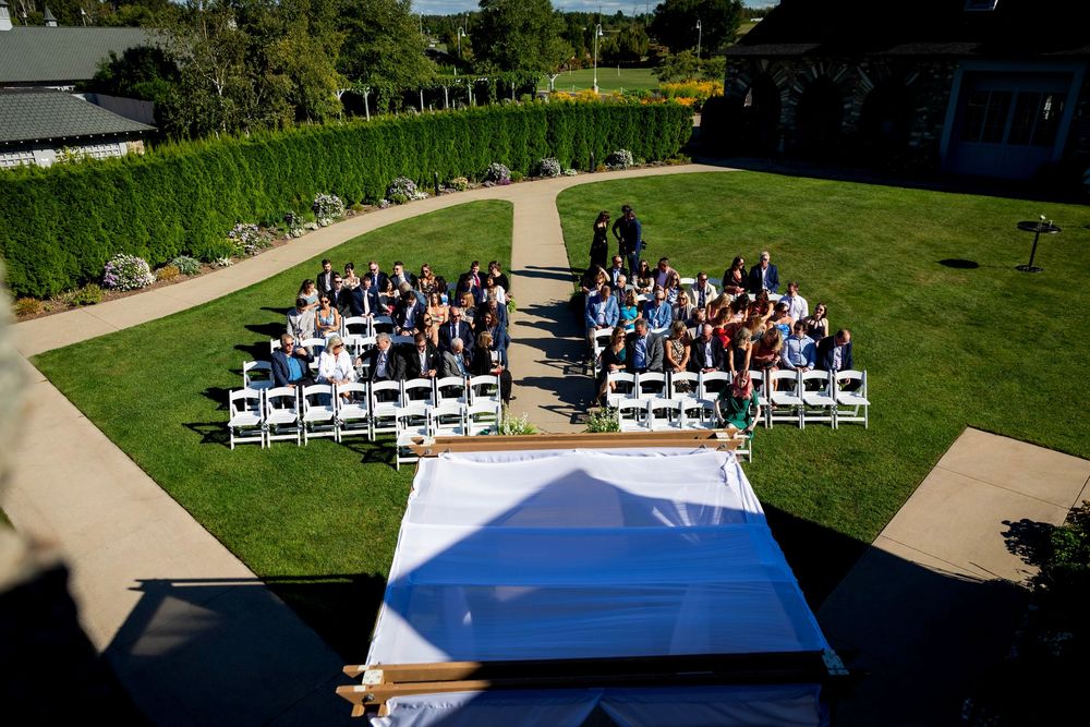 A birds eye view of wedding guests waiting for the bride to walk down the aisle at a summer outdoor wedding located at the knights courtyard