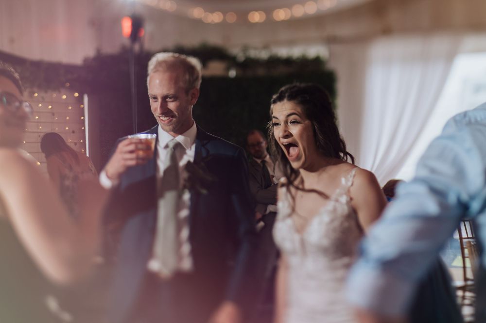 Couple shares an intimate dance moment under warm lighting at their wedding reception.