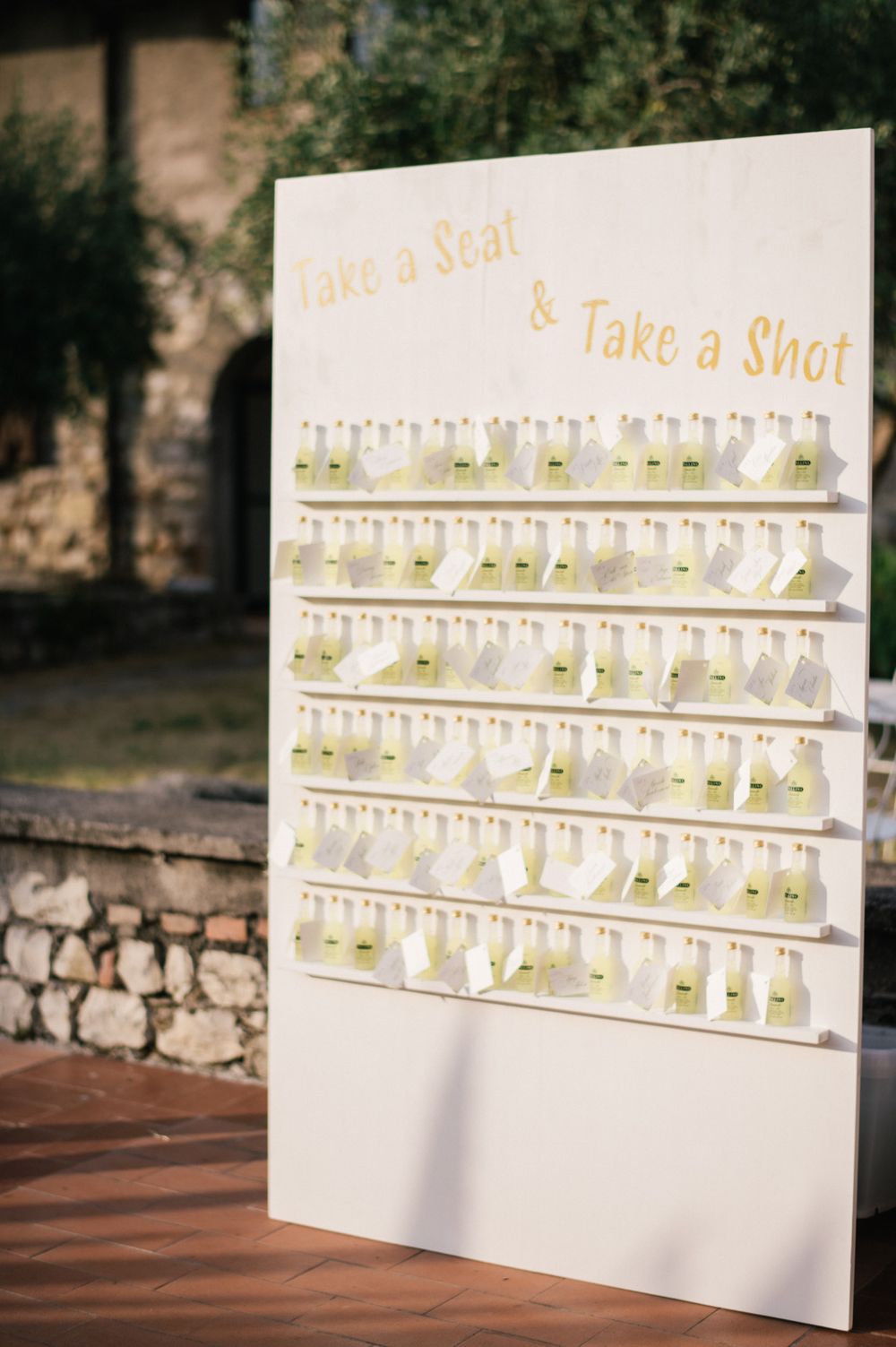 Original table plan made with mini limoncello bottles for a destination wedding on Lake Iseo