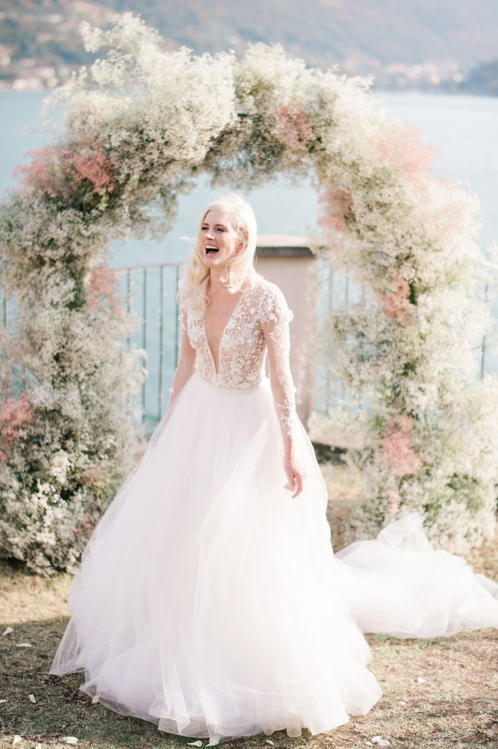 Happy bride celebrating her joy during the ceremony overlooking lake Iseo