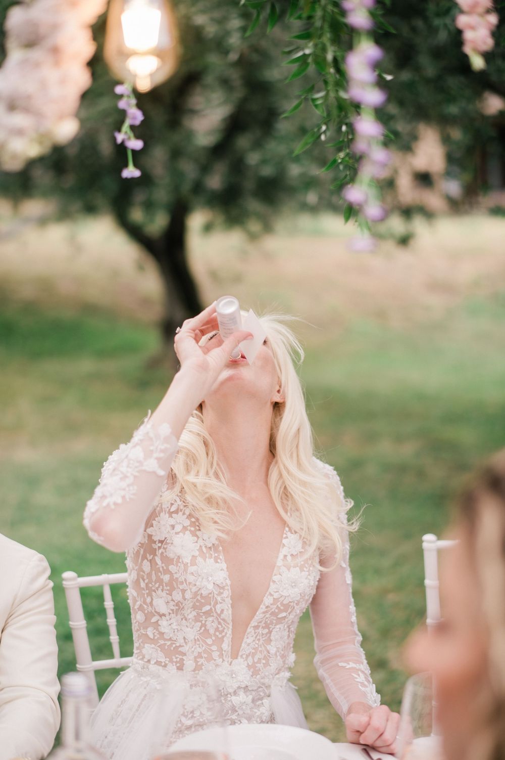 Bride enjoying her limoncello during her wedding reception on an island at Lake Iseo