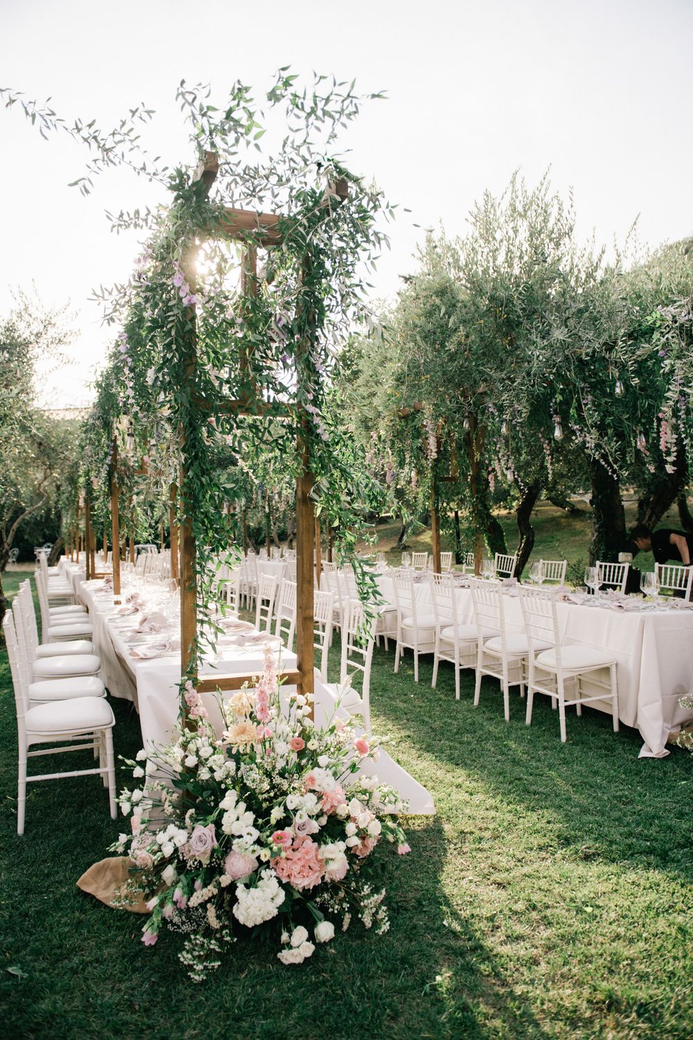 Rustic elegant wedding reception set up in the olive garden of the historic island residence