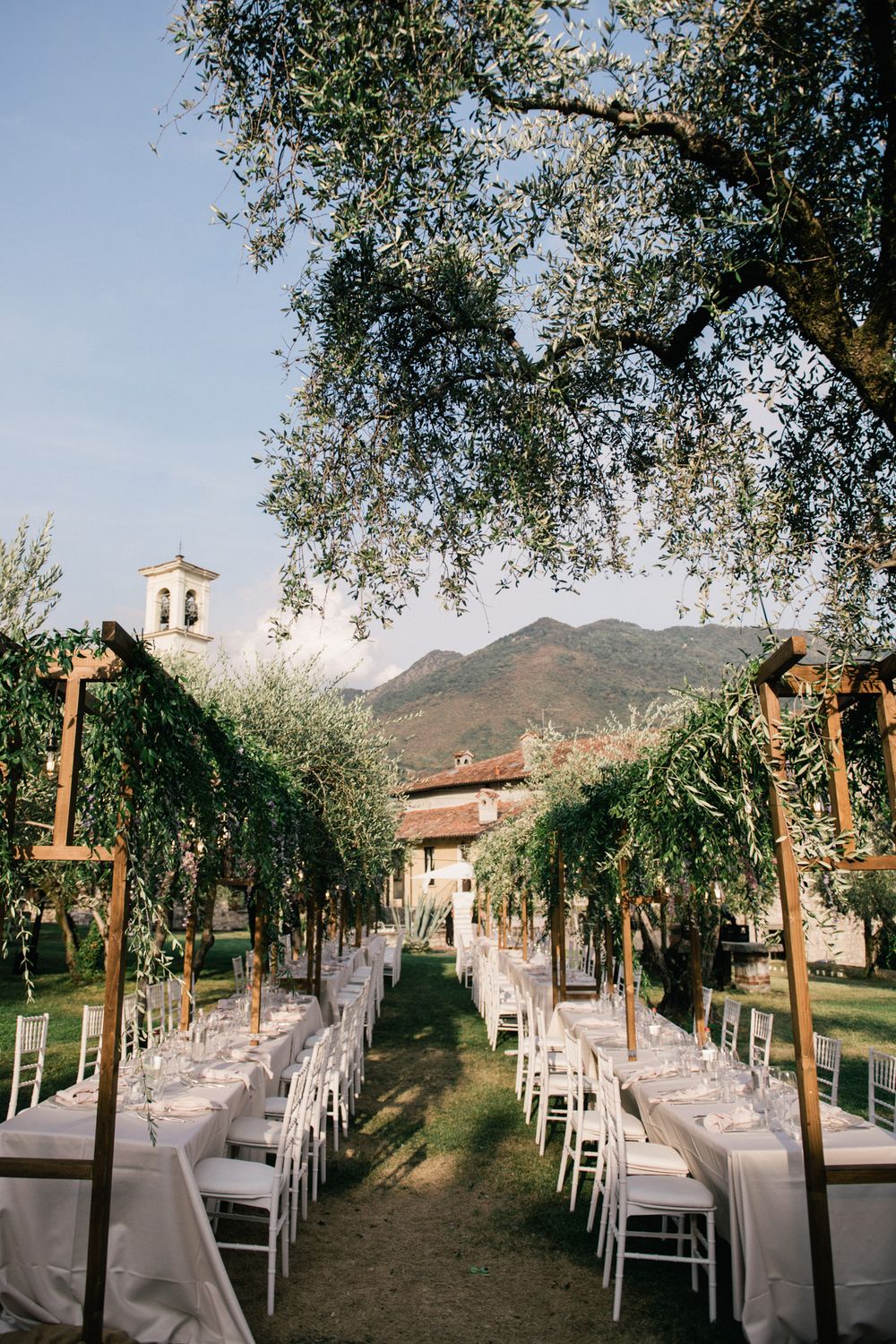 Rustic elegant wedding reception set up in the olive garden of the historic island residence