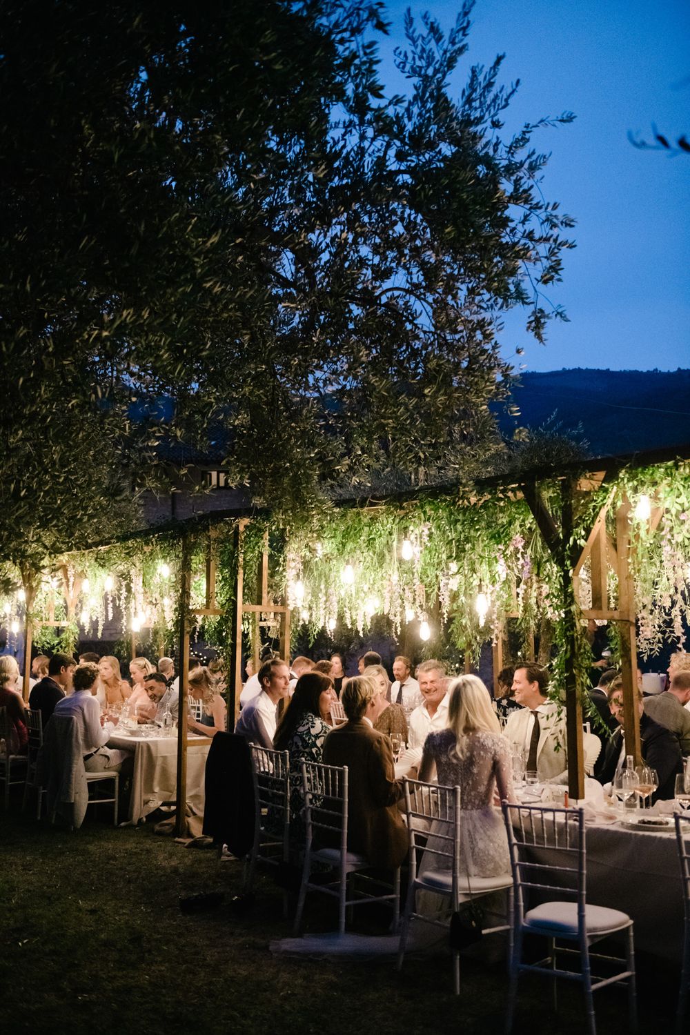Rustic elegant wedding reception set up in the olive garden of the historic island residence