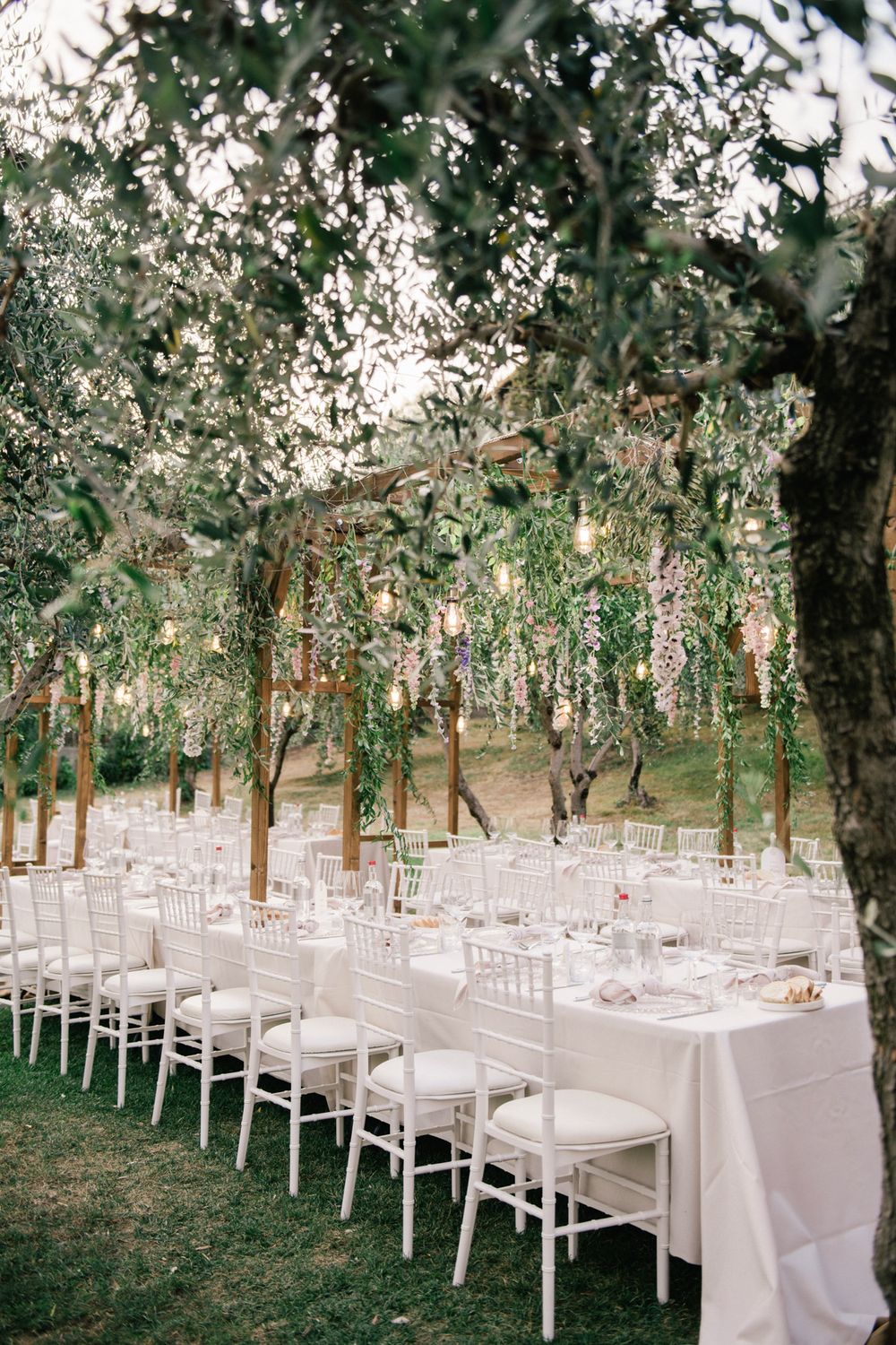 Rustic elegant wedding reception set up in the olive garden of the historic island residence