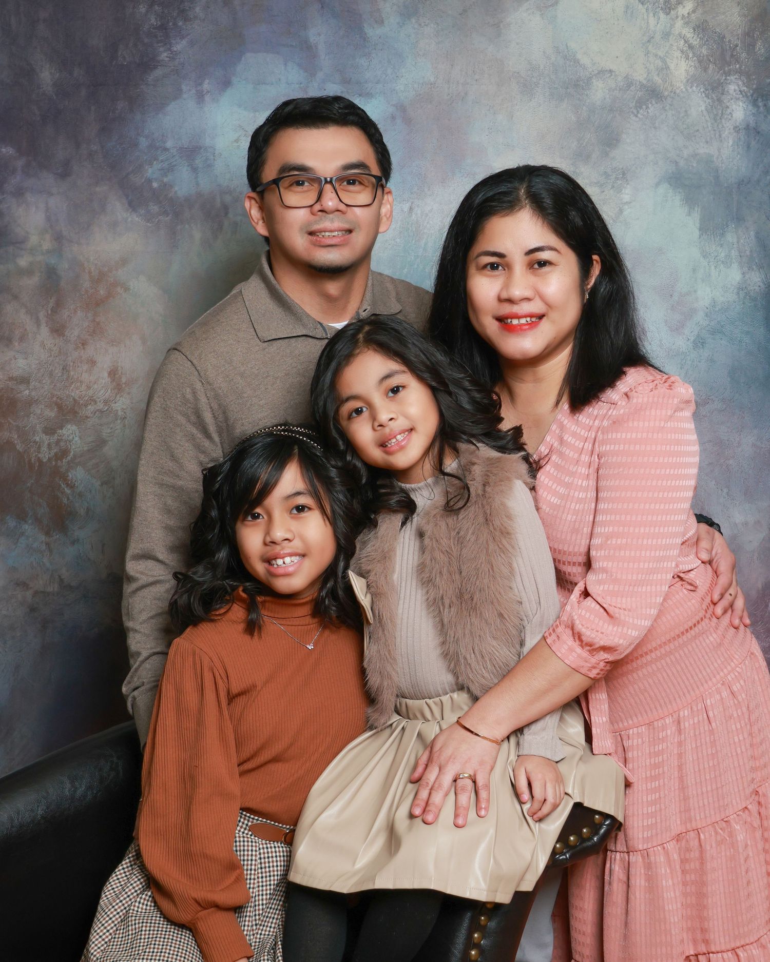 Family studio portrait with soft lighting and neutral backdrop in Miramichi