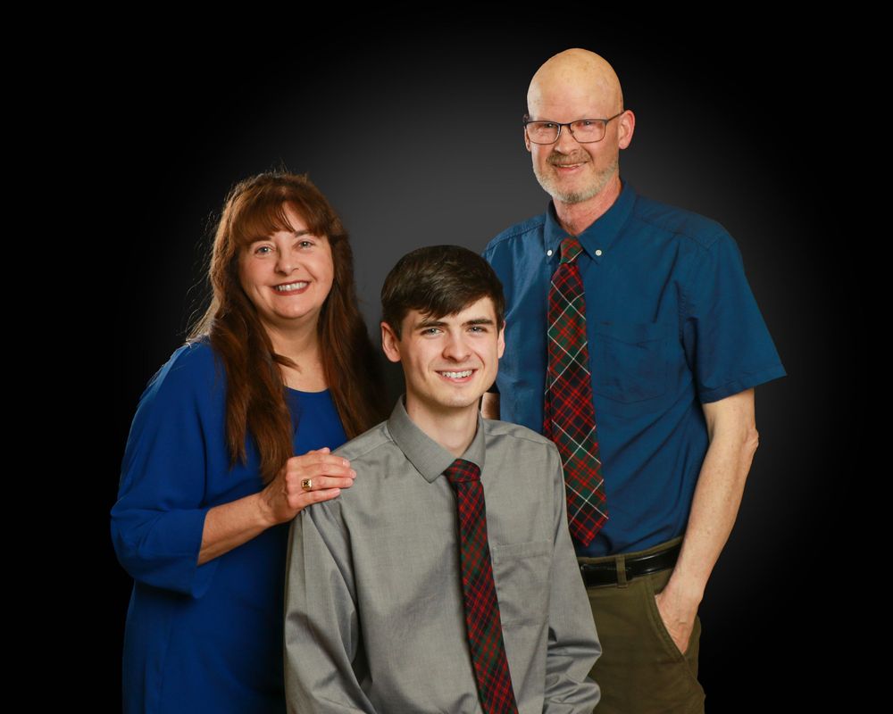 Family studio portrait with soft lighting and neutral backdrop in Miramichi