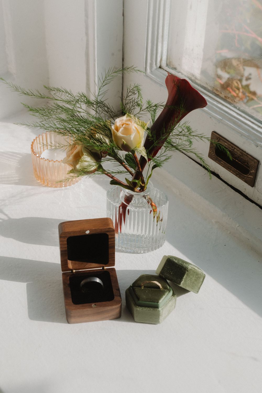A series of minimalist still life photos featuring flowers and small boxes on a white windowsill.