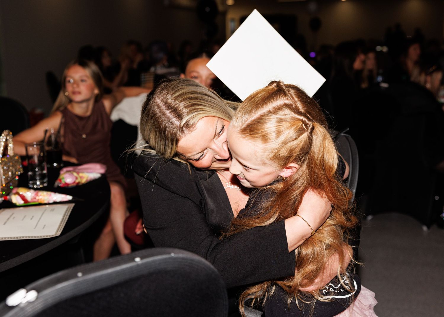 A series of photos showing people hugging and embracing at what appears to be a social gathering or event.