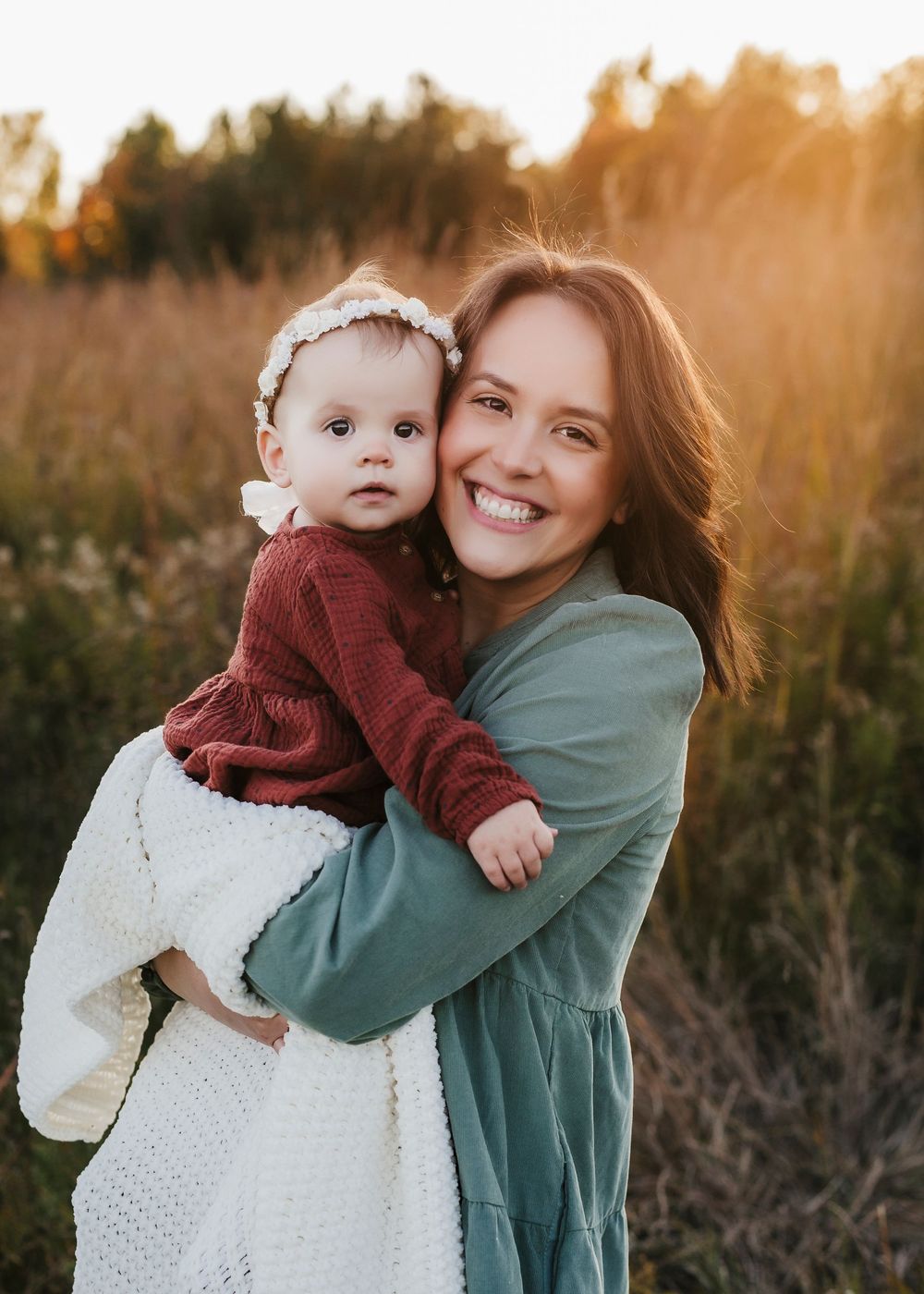 A tender moment captured in golden sunlight amidst autumn foliage.