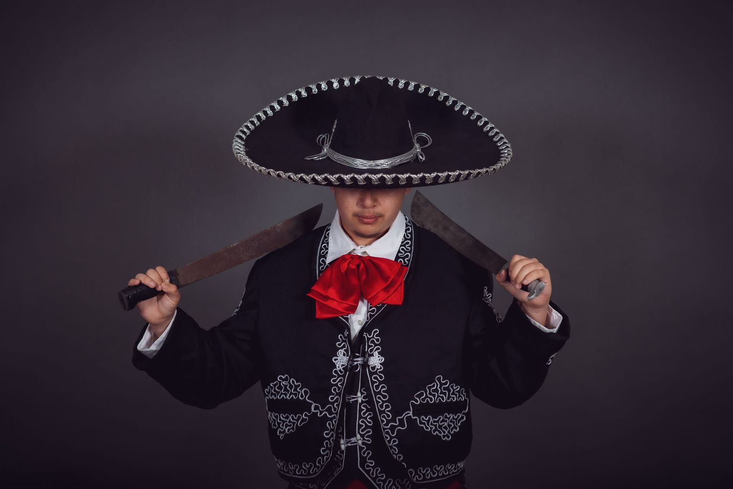 A series of photos showing a traditional Mexican mariachi outfit with embroidered details and a black sombrero.