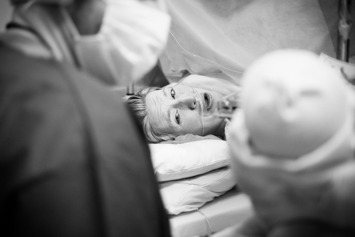 Black and white moment of mom meeting her baby for the first time.