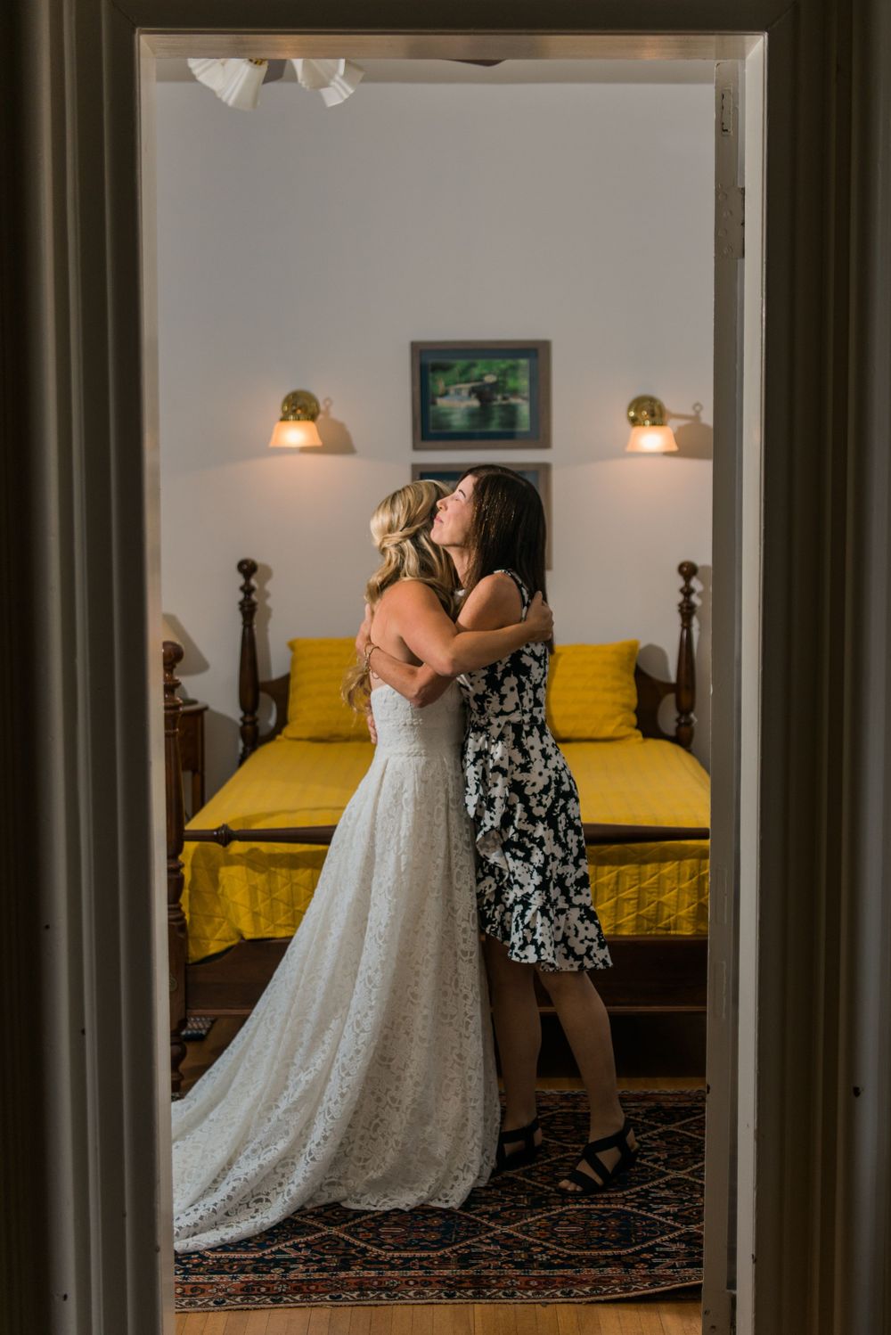 Wedding dress preparation embrace with bride and mom. Special moments, for sure!