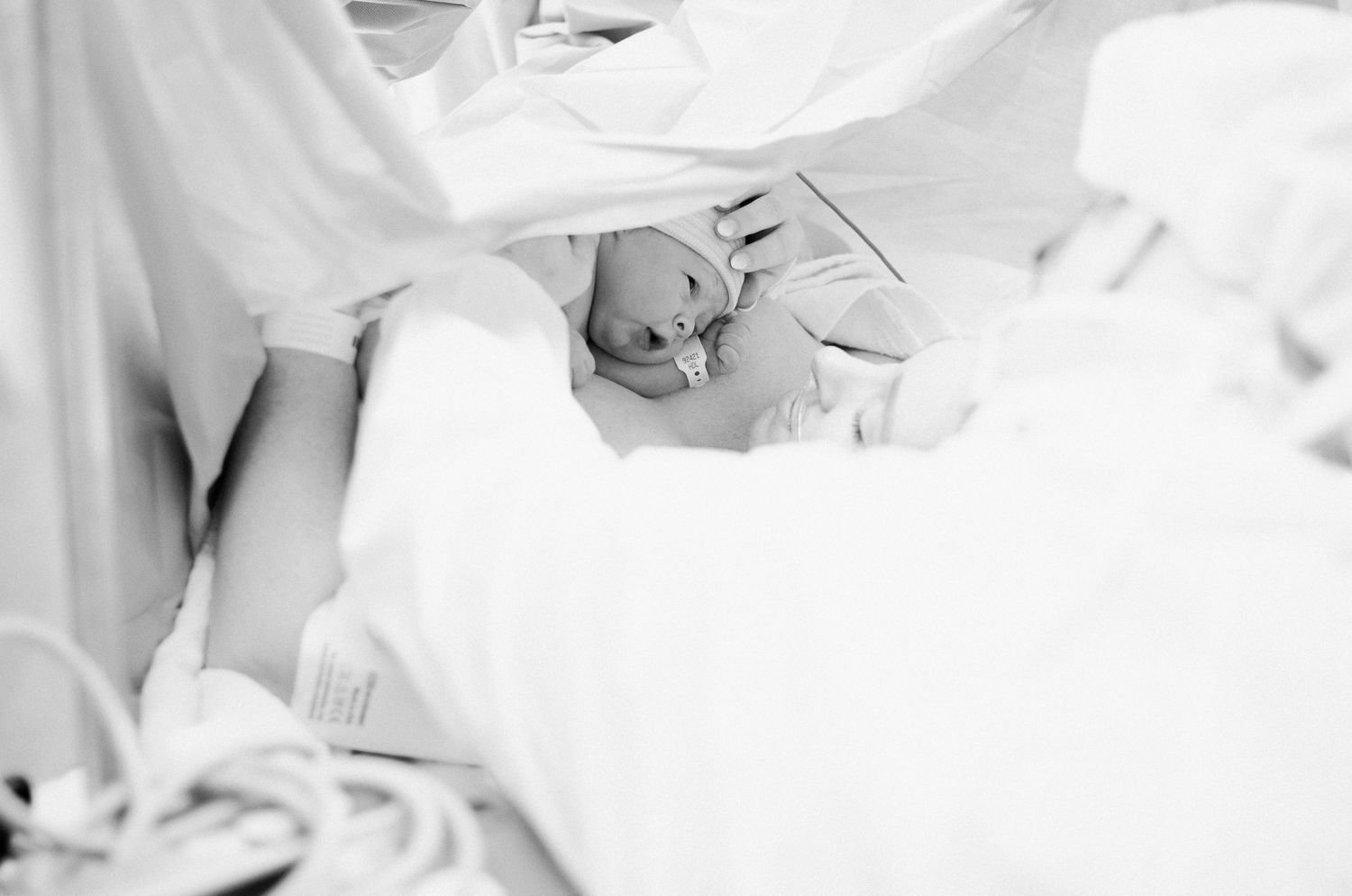 Black and white moment of moms first moments with her new baby.