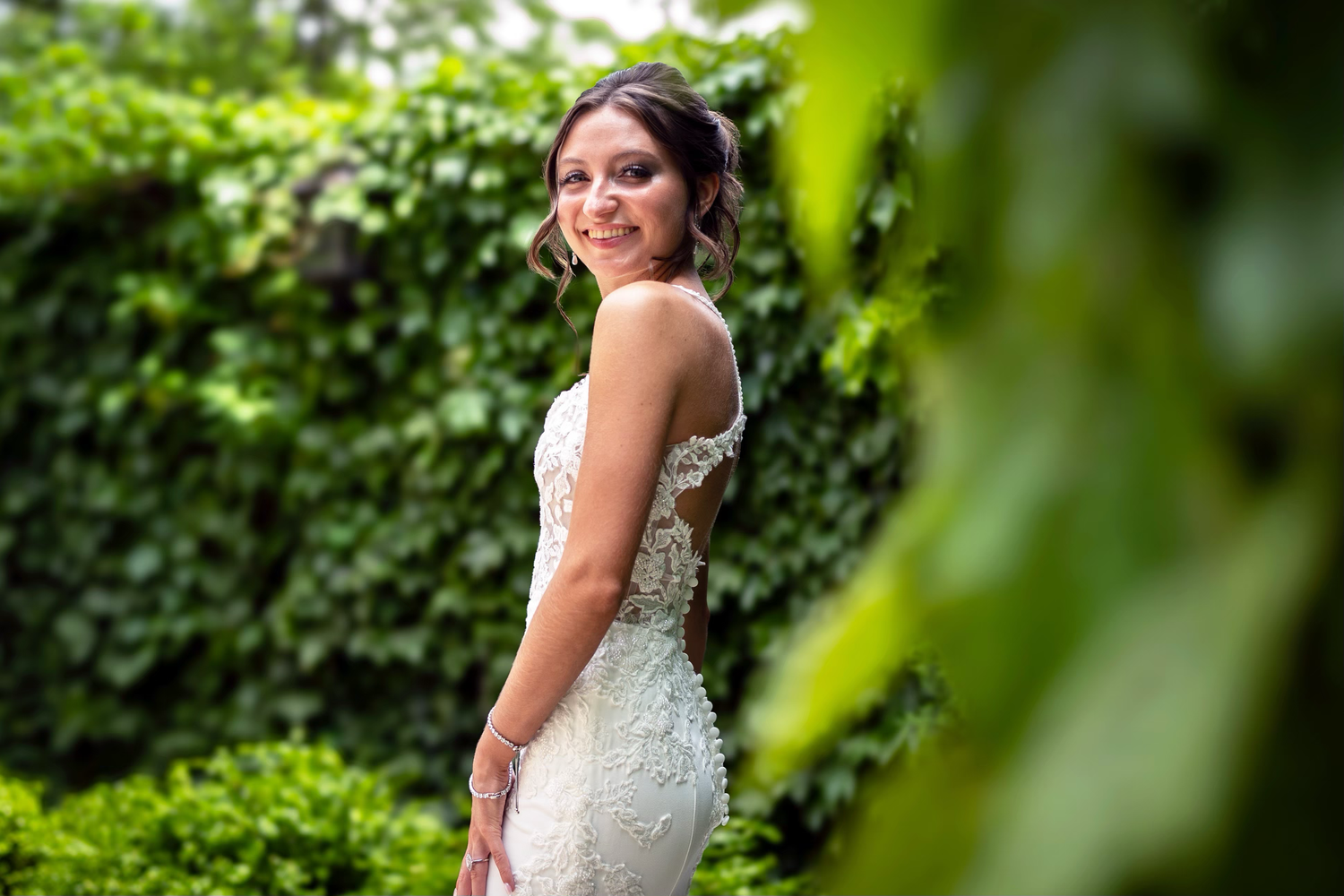 Beautiful bride in lace wedding dress poses in the club at corazon garden
