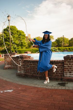 A sequence of graduation photos shows a person in a blue cap and gown doing a celebratory dance on a brick wall.