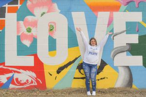 Colorful street art mural featuring vibrant text and graffiti-style letters on an urban wall.