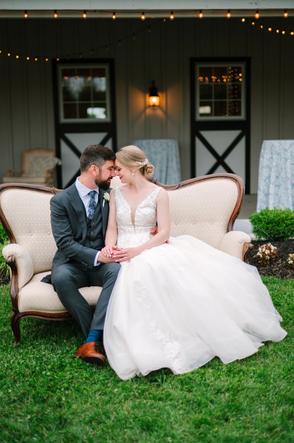 A romantic series of wedding photos showing a couple reclining on vintage chairs in a garden setting at sunset.