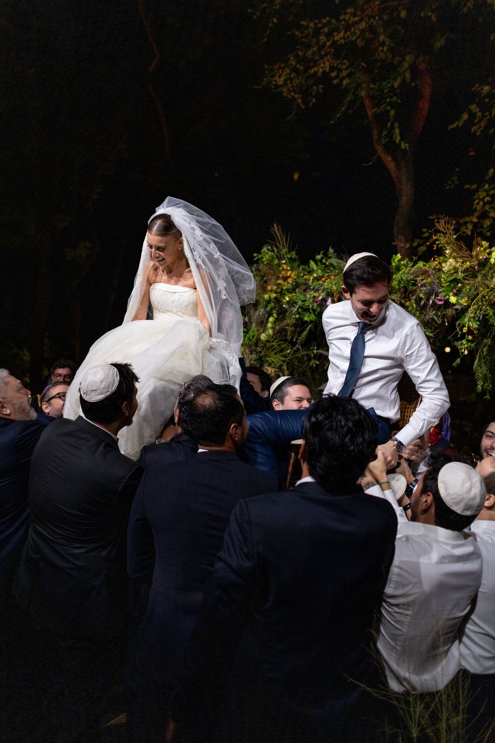 A sequence of wedding celebration photos showing guests lifting and carrying someone in a traditional Jewish celebration.