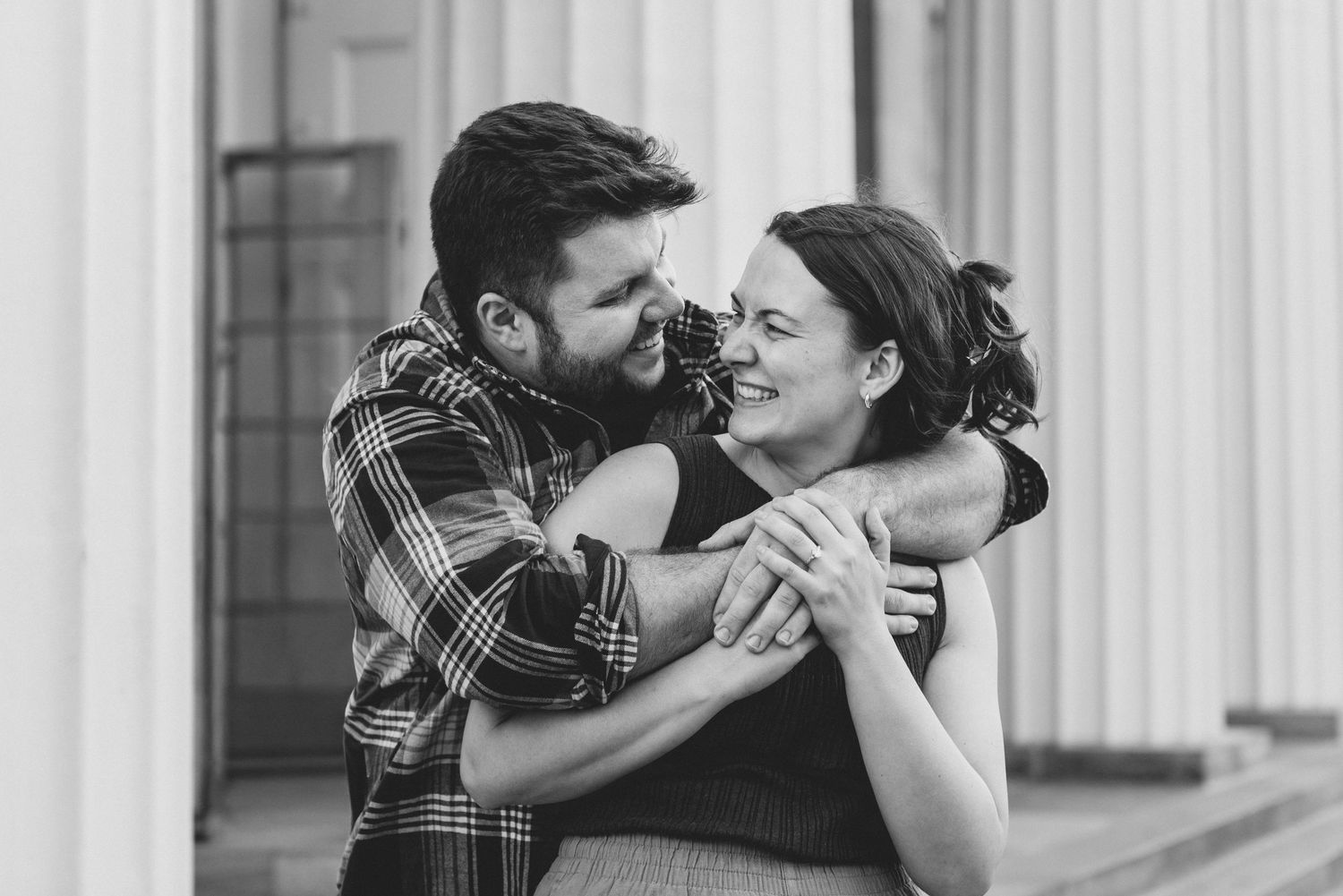 A black and white photo collage showing three romantic couples embracing and kissing in an elegant setting.