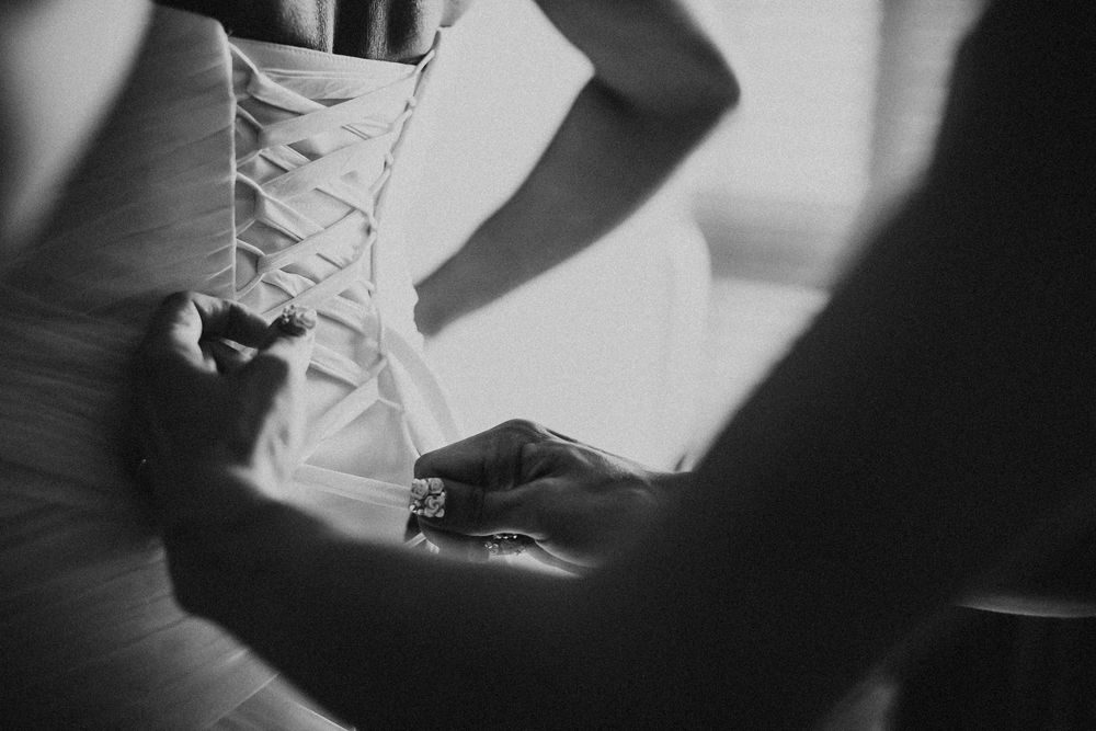 Black and white photograph showing a ballet dancer's feet in pointe shoes performing a graceful movement.
