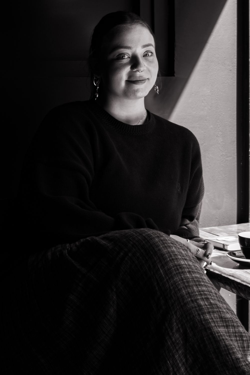 Black and white portrait with dramatic window lighting.