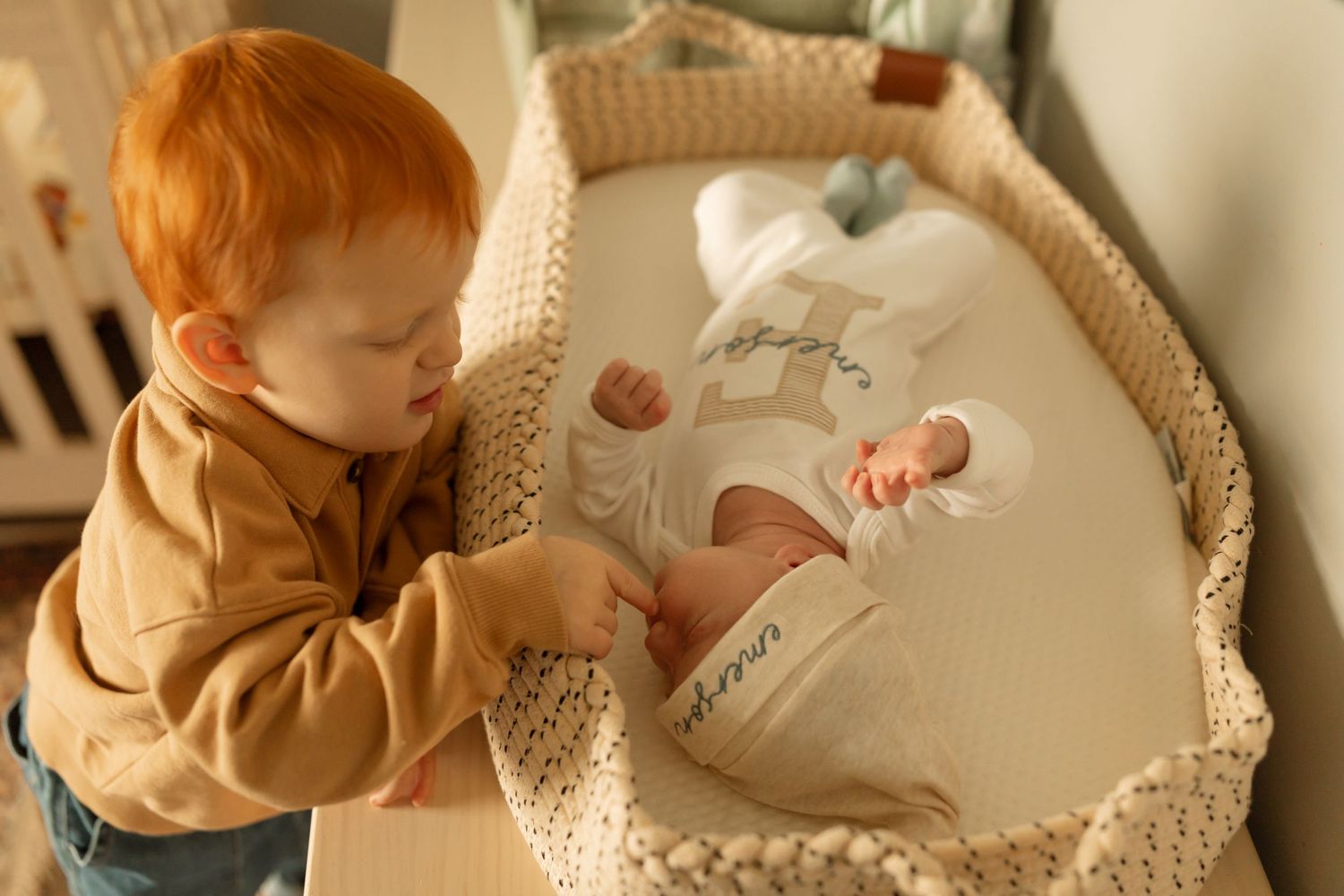 Nursery scene with tan colored decorative elements and soft textiles.