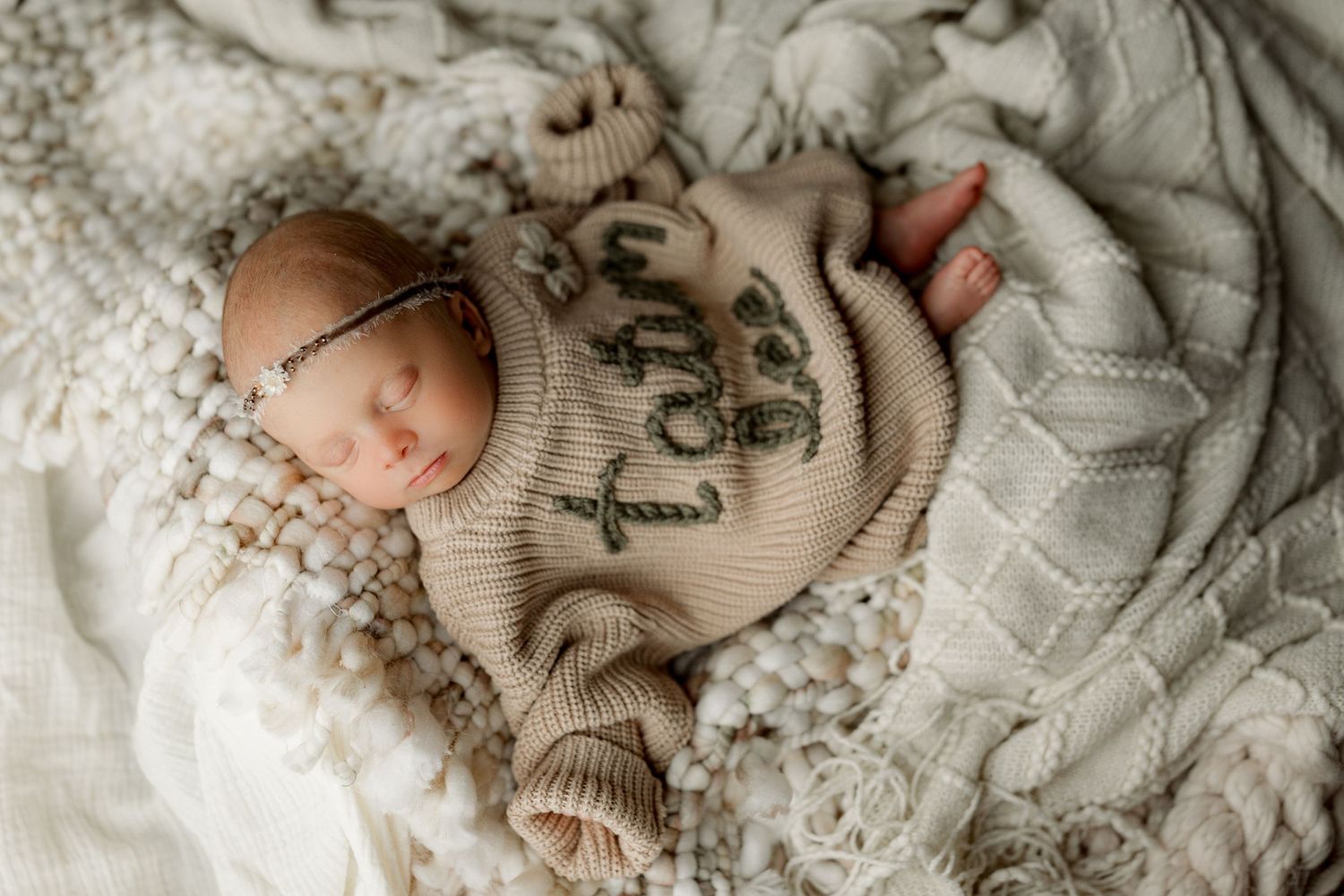Delicate lace and knitted textures in neutral tones create a soft, vintage-inspired composition.
