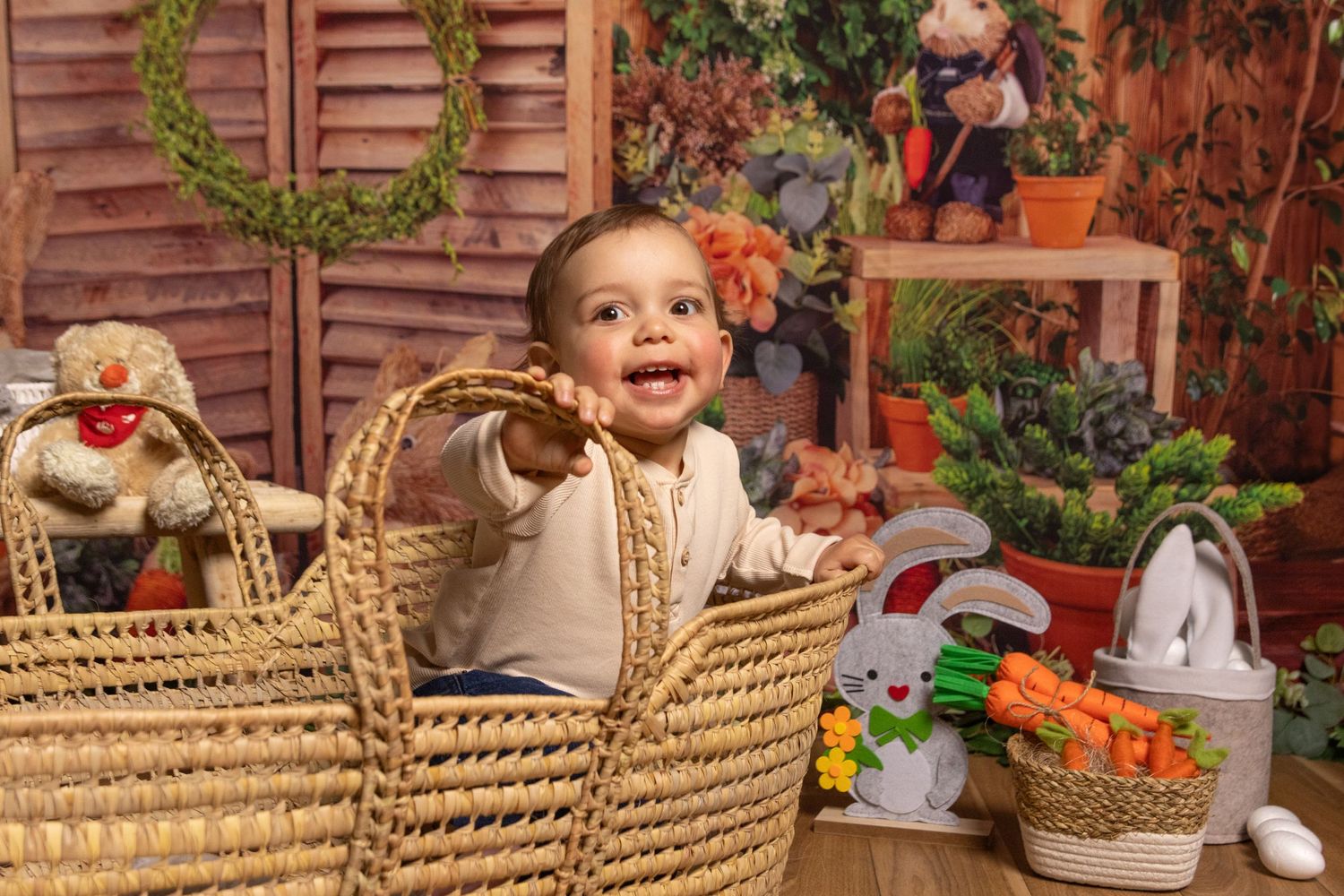 Candid shots of a child sitting in a wicker basket with floral decorations and wooden shutters in background.