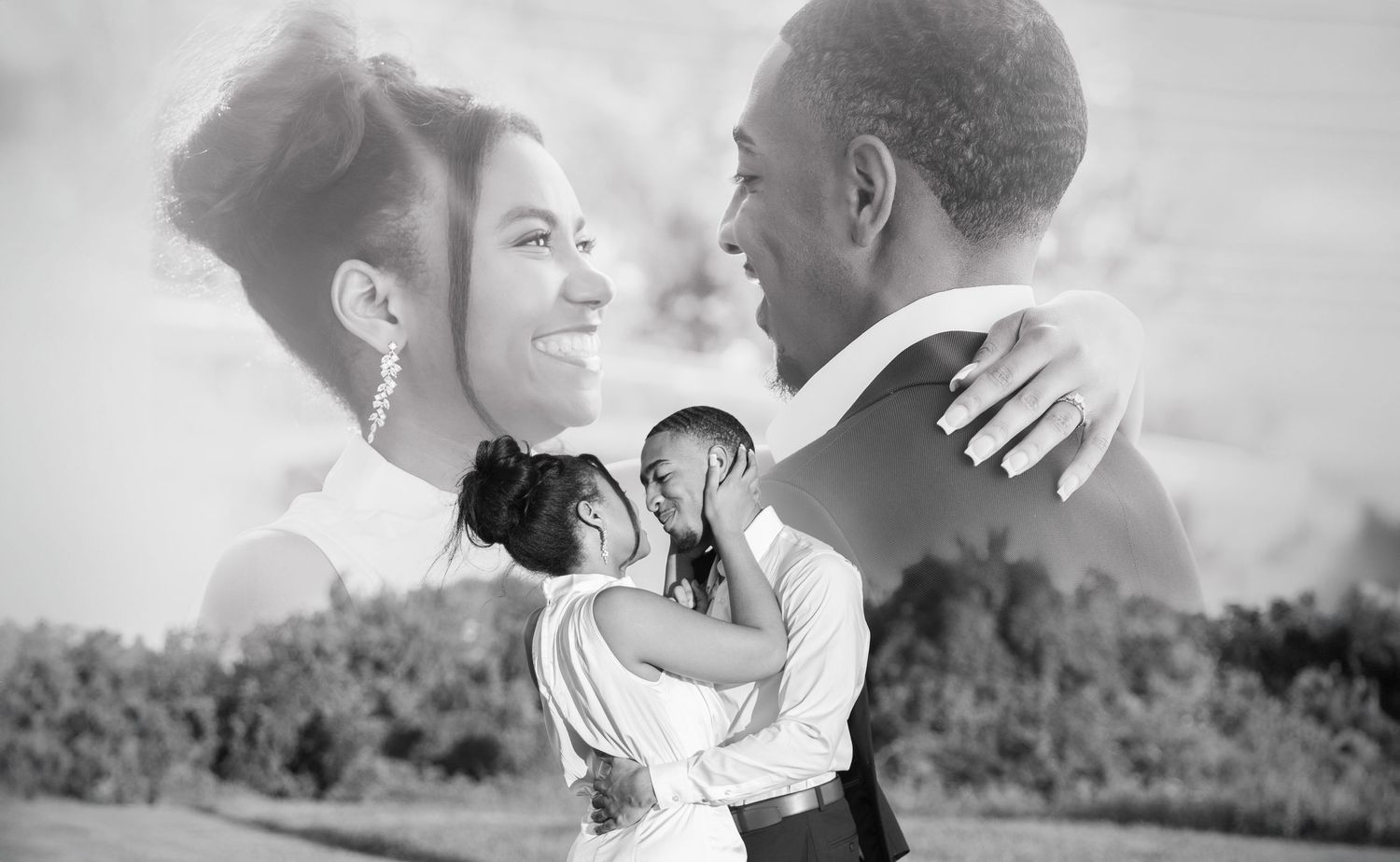 Black and white double exposure wedding portrait of smiling couple embracing with scenic landscape in the background.