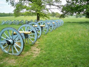 Row of light blue Civil War cannons lined up on a grassy hill at Valley Forge National Historical Park.