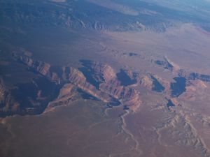 Deep red canyons and mesas photographed from above in the American Southwest.