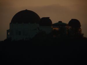 Silhouettes of houses against a dusky sky during sunset.