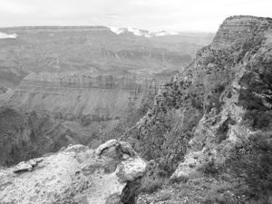Black and white panorama of rugged canyon walls and steep cliffs in the Grand Canyon.