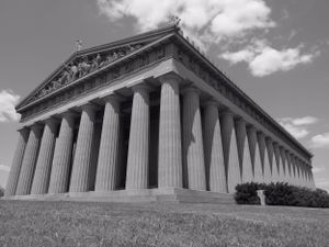 Black and white panoramic view of the Parthenon-style building with dramatic columns and steps.