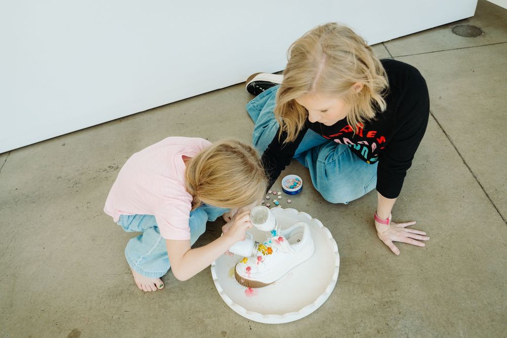 Wizzy Fizzies founder Angie mixing colors with her kids during a Denver brand photography session with McGlone Photography.