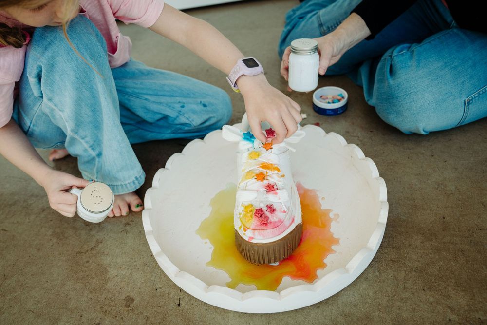 Wizzy Fizzies founder Angie mixing colors with her kids during a Denver brand photography session with McGlone Photography.